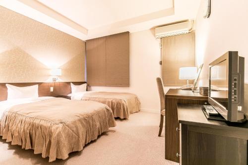 Postel nebo postele na pokoji v ubytování Petit Hotel Enchante
