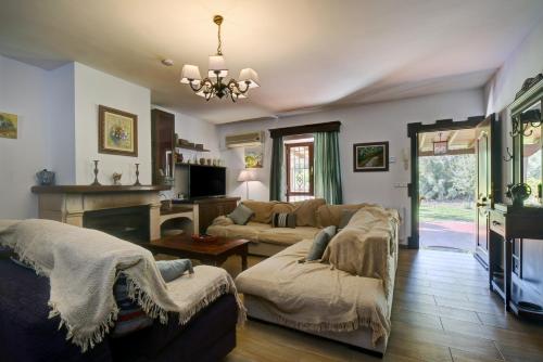 a living room with a couch and a table at Villa Carmen in Ronda