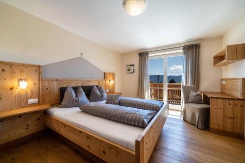 a bedroom with a large bed and a large window at Alber Ferienwohnung Mürri in Verano