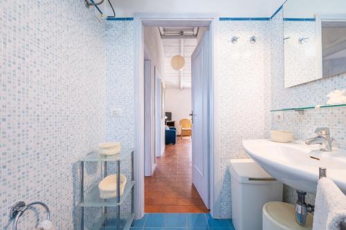 a bathroom with a sink and a toilet at Casa Luisella in Costa Rei