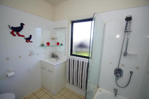 a bathroom with a shower and a toilet and a sink at Riverview Retreat in Kerikeri