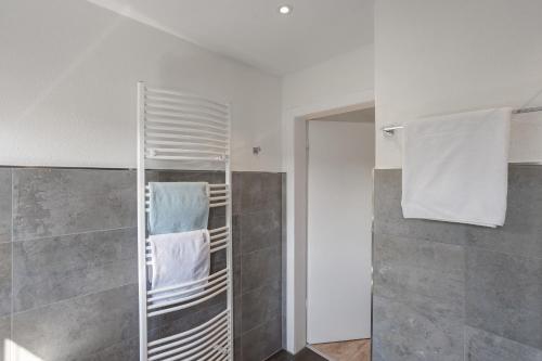 a bathroom with a towel rack and a shower at Haus Marianne in Arnsberg