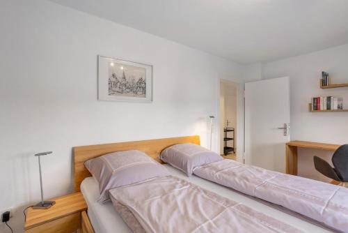 a bed with two pillows on it in a room at Haus Marianne in Arnsberg