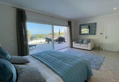 a bedroom with a bed and a sliding glass door at Gloriann in Moraira