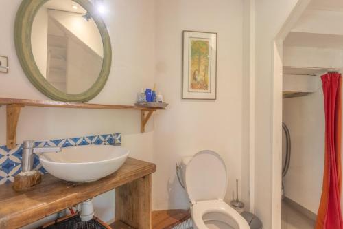 a bathroom with a sink and a toilet and a mirror at Peaceful Countryside Getaway in Parbayse
