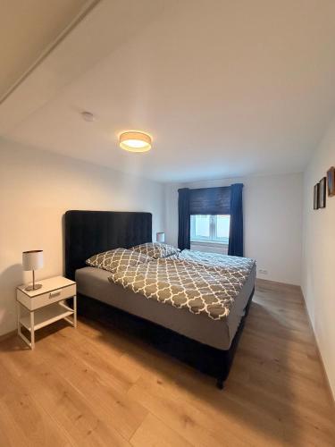 a bedroom with a large bed and a window at Fewo im schönen Allensbach in Allensbach