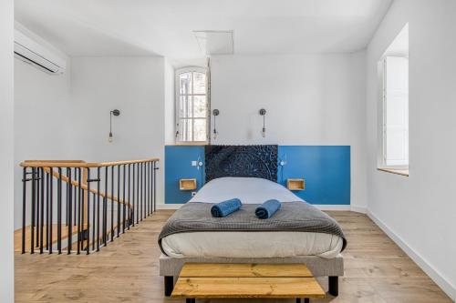 a bedroom with a large bed with blue walls at Les gîtes de virginie in Bourg-sur-Gironde
