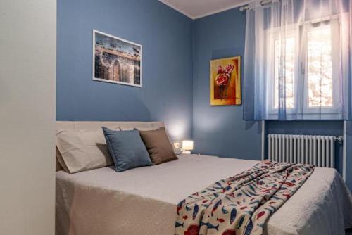 a bedroom with a large bed with blue walls at Villa Galatea Stella Marina in Capoliveri