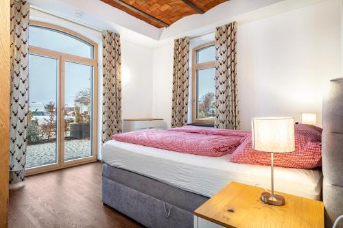 a bedroom with a large bed and a window at Käserei in Argenbühl