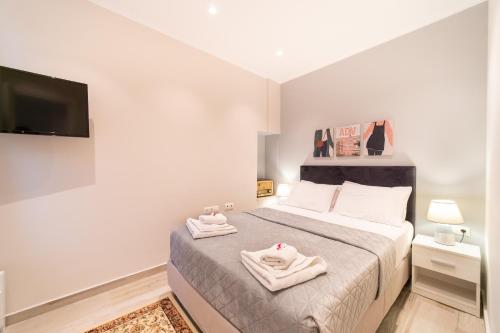 a bedroom with a bed with two towels on it at Seawind Gouvia in Corfu