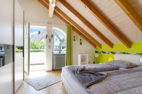 a bedroom with two beds and a large window at Wohlfühlplatz in Ostrach
