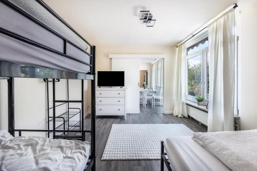 a bedroom with a bunk bed and a television at Haus am See in Quickborn