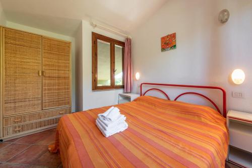 a bedroom with a bed with towels on it at Accu is Prezzus E special 50m mare in Villasimius