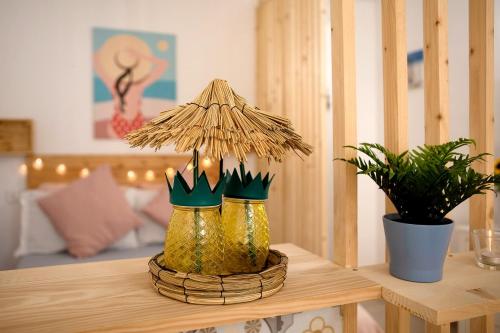 a table with a lamp and two plants on it at Vista Al Paraíso in El Pris