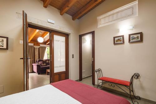 a bedroom with a bed and a chair in a room at O Pozo in Ordes