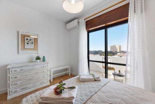 a bedroom with a bed and a dresser and a window at Dreamalvor in Alvor