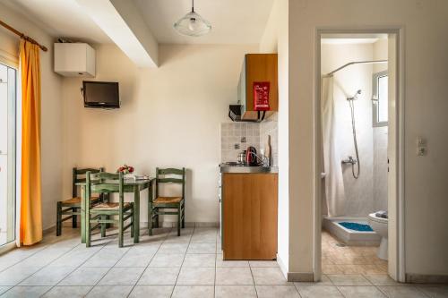 a kitchen and dining room with a table and chairs at Anemona apartment 1 in Kefallonia