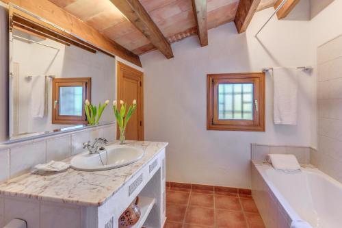 a bathroom with a sink and a bath tub and a tubermott at Can Vaja in Pollença
