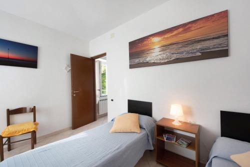 a small bedroom with a bed and a desk and a window at Trilocale San Nazario in Varazze
