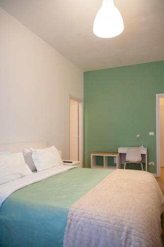 a bedroom with a large bed and a desk at Oltremare in Molfetta