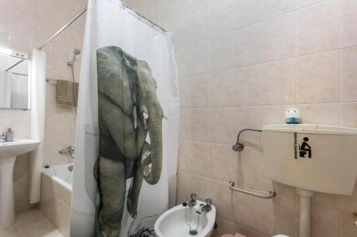 an elephant in a shower curtain in a bathroom at Geo House in Vila do Bispo