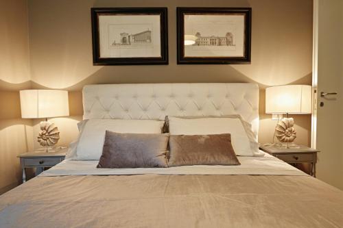 a bedroom with a bed with two lamps on both sides at Villa Grazia in Manerba del Garda