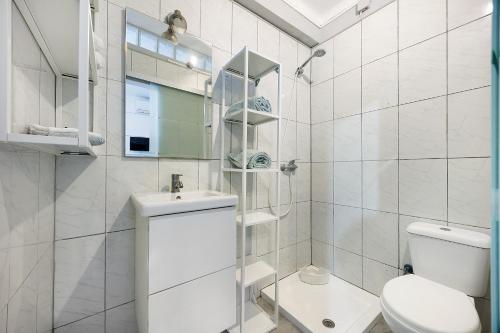 a white bathroom with a toilet and a sink at Economy Studio for Two in Lagos in Lagos