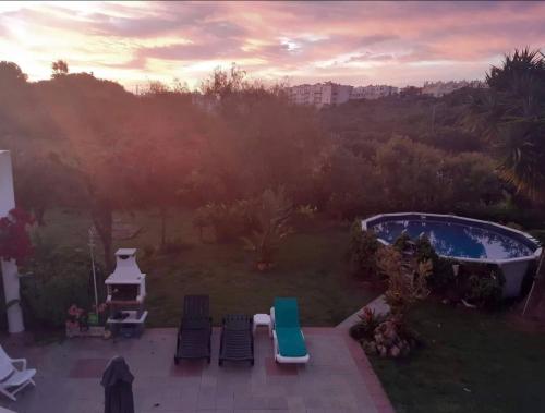 an aerial view of a backyard with a pool and chairs at Economy Studio for Two in Lagos in Lagos