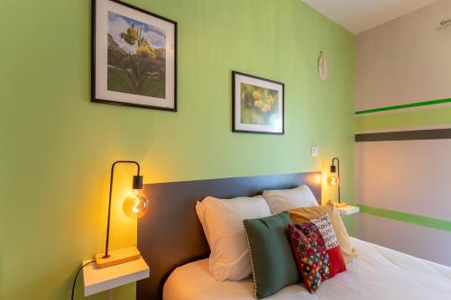 a bedroom with a bed with two lamps on it at Chambre - Lis in Aroue