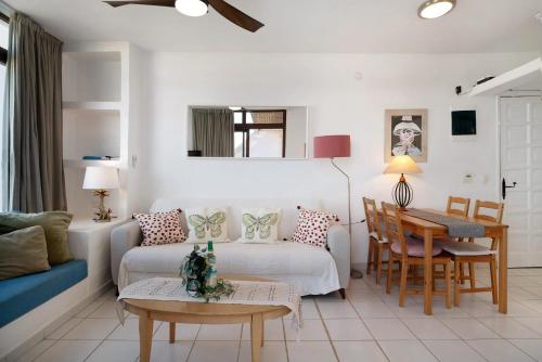 a living room with a couch and a table at Los Molinos 4306 in Costa Teguise