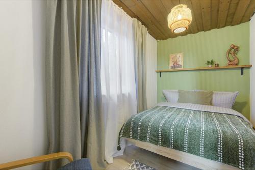 a bedroom with a bed next to a window at Ferienhaus am Neubäuer See in Roding