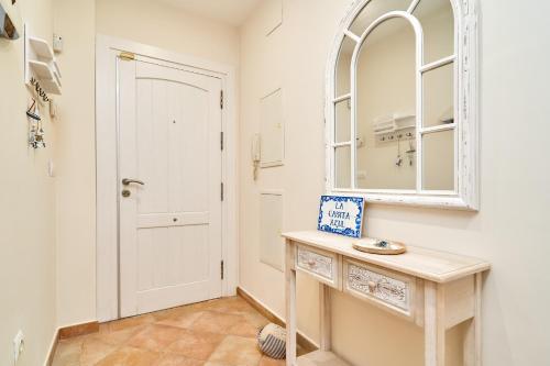 a bathroom with a sink and a mirror at La Casita Azul in Almuñécar