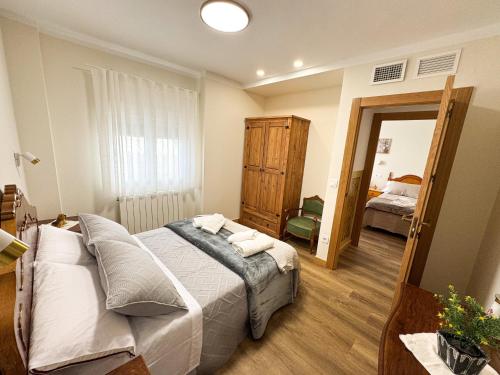a bedroom with a bed with pillows and a mirror at Casa rural La abuela in Mainar