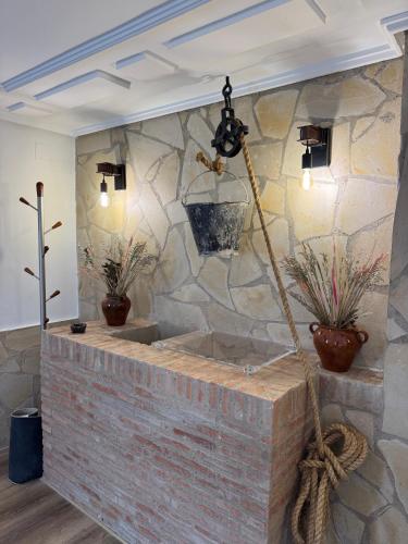 a stone wall in a bathroom with a tub at Casa rural La abuela in Mainar