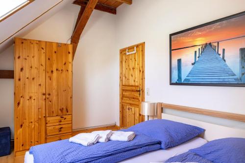 a bedroom with a bed and a painting on the wall at Forsthof Schulte in Pronstorf