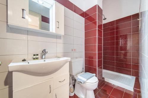 a bathroom with a toilet and a sink at Arianna Studio Ground Floor 3 in Paleokastritsa