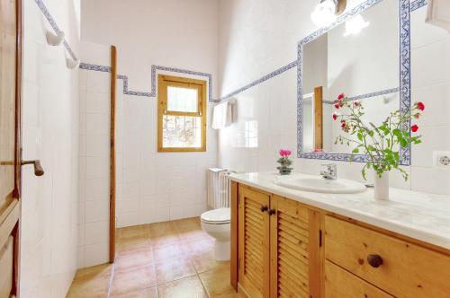 a bathroom with a sink and a toilet at Na Garrovera in Pollença