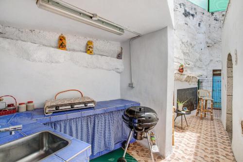 a kitchen with a sink and a blue counter top at Casa Bene in Güimar