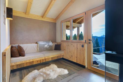 a living room with a couch and a window at Chalet Hugo in Verano