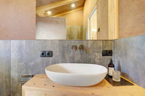 a bathroom with a large white sink on a counter at Chalet Hugo in Verano