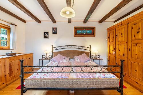a bedroom with a metal bed in a room at Blockhaus Paepke in Mühlenbach