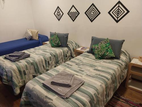a room with two beds with towels on them at Cerro Chaltén House - Deptos in El Chalten