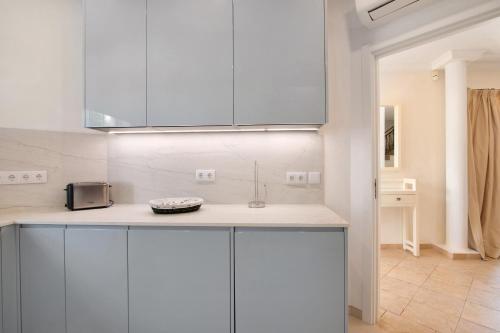 a kitchen with white cabinets and a counter top at Casa Valerie in Vale do Lobo