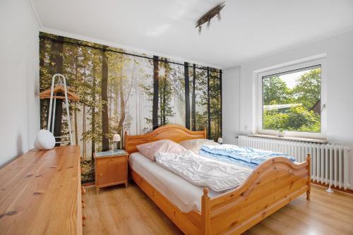a bedroom with a wooden bed and a window at Haus Gerda in Stadum