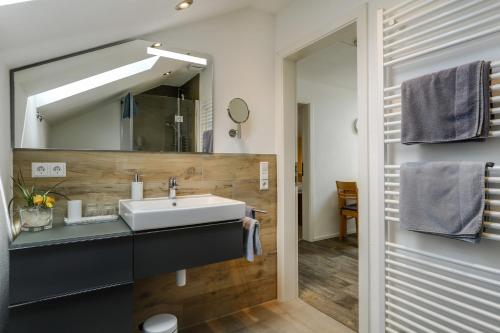 a bathroom with a sink and a mirror at Ferienwohnung Irmi in Hergensweiler