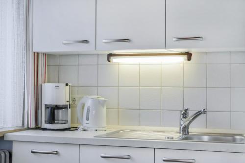 a kitchen with a sink and a coffee maker at Ferienwohnung Wennesz 1 in Chieming