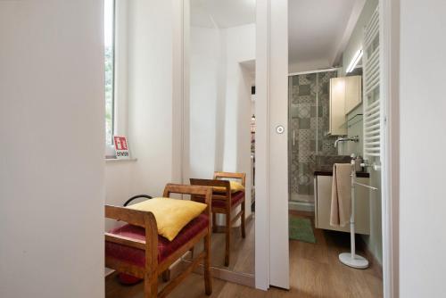 a room with two chairs and a table and a sink at Giada's Retreat - Genova Nervi in Genoa