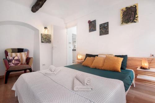 a bedroom with a bed with two towels on it at Giada's Retreat - Genova Nervi in Genoa