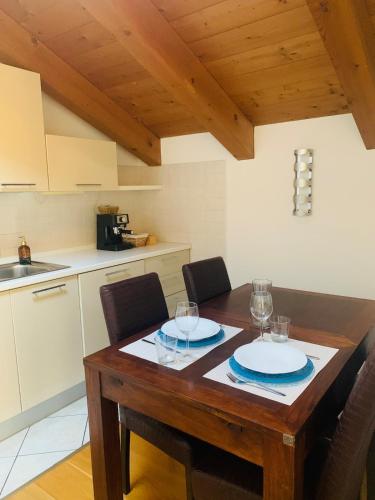 a kitchen with a wooden table with glasses on it at Il Rifugio di Palmanova in Palmanova