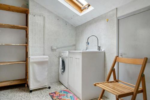 a laundry room with a sink and a washing machine at Albachiara in Rapallo